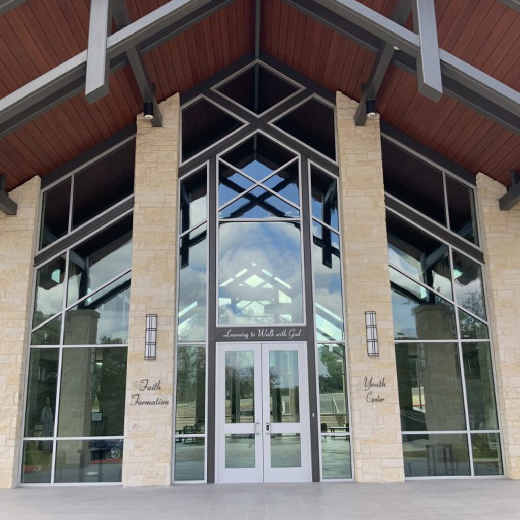 Exterior of St. Elizabeth Ann Seaton Church with white stone columns and metal framing on the roof.