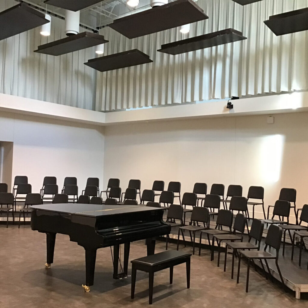 Interior of music room with chairs and a piano.